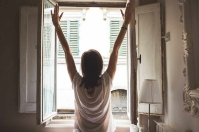 Woman stretching by window