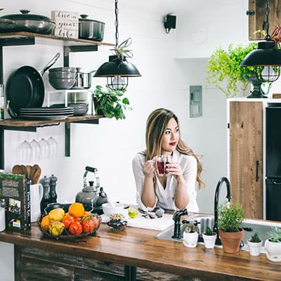 Woman drinking tea in her kitchen