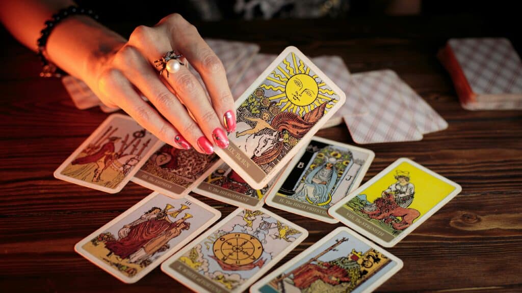 Person holding tarot cards for holiday cottage mortgage advice.
